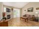 Cozy living room with fireplace, plush sofa, and sliding glass doors, offering a warm and inviting space at 22163 E Calhoun Pl, Aurora, CO 80016