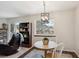 Well lit dining area featuring a modern chandelier, area rug, and exterior views at 771 Canyon Dr, Castle Rock, CO 80104