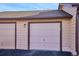 Two-car garage with doors in neutral earth-tone colors, complete with house number 771 at 771 Canyon Dr, Castle Rock, CO 80104