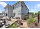 Back of house featuring a patio area with fountain, seating area, and landscaped garden at 18126 E Alamo Dr, Centennial, CO 80015