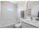 Bright and clean bathroom with a shower-tub combo, white vanity, and modern fixtures at 18126 E Alamo Dr, Centennial, CO 80015
