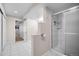 Bathroom featuring white tile flooring, an enclosed shower, and toilet separated by a wall at 18126 E Alamo Dr, Centennial, CO 80015