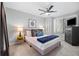 Cozy bedroom featuring a modern ceiling fan, plush pillows and blanket, and neutral decor at 18126 E Alamo Dr, Centennial, CO 80015