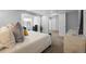 Open bedroom featuring a bed with decorative pillows, a window, and dual closets at 18126 E Alamo Dr, Centennial, CO 80015
