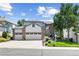 Inviting two-story home featuring a three-car garage, brick accents, and well-manicured landscaping at 18126 E Alamo Dr, Centennial, CO 80015