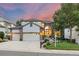 Inviting two-story home featuring a three-car garage, brick accents, and well-manicured landscaping at 18126 E Alamo Dr, Centennial, CO 80015