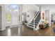Bright foyer with hardwood floors, high ceilings, grand staircase, and natural light at 18126 E Alamo Dr, Centennial, CO 80015