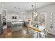 Bright open kitchen and dining area featuring stainless steel appliances, a kitchen island, and patio access at 18126 E Alamo Dr, Centennial, CO 80015