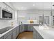 Well-appointed kitchen featuring stainless steel appliances, a sink, and a stylish design with white subway tile backsplash at 18126 E Alamo Dr, Centennial, CO 80015