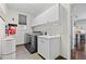 Laundry room with cabinets, front-load washer and dryer, tiled floors, and a utility sink at 18126 E Alamo Dr, Centennial, CO 80015
