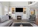 Living room boasts a stone fireplace, built-in cabinets, and large windows for natural light at 18126 E Alamo Dr, Centennial, CO 80015