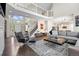 Open-concept living area featuring hardwood floors, a staircase, and a view into the kitchen at 18126 E Alamo Dr, Centennial, CO 80015