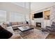 Cozy living room features a stone fireplace, built-in cabinets, and natural light at 18126 E Alamo Dr, Centennial, CO 80015