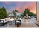 Outdoor patio featuring a modern fire pit, comfortable seating, and a professionally landscaped backyard at 18126 E Alamo Dr, Centennial, CO 80015