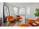 Open-concept interior with stylish chairs, hardwood floors and interior arches at 18126 E Alamo Dr, Centennial, CO 80015