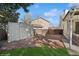 Fenced backyard featuring a storage shed, garden area, and lush green grass at 4762 S Clay Ct, Englewood, CO 80110