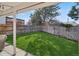 Private fenced backyard with a well-manicured lawn and covered patio at 4762 S Clay Ct, Englewood, CO 80110