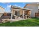 Cozy covered patio featuring comfortable seating and a view of the manicured lawn at 4762 S Clay Ct, Englewood, CO 80110
