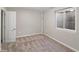 This basement bedroom features neutral carpet and paint and a egress window and closet at 4762 S Clay Ct, Englewood, CO 80110