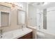 This bathroom features a double sink, chrome fixtures, and a shower and tub with gray and white tile at 4762 S Clay Ct, Englewood, CO 80110