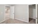 This carpeted bedroom features neutral paint and walk-in closet and access to the main area at 4762 S Clay Ct, Englewood, CO 80110