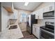 Stylish kitchen with stainless steel appliances, white subway tile backsplash, and granite countertops at 4762 S Clay Ct, Englewood, CO 80110
