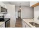 Modern kitchen view with stainless steel appliances, granite counters, and seamless access to living areas at 4762 S Clay Ct, Englewood, CO 80110