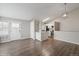 Open-concept living room with hardwood floors and natural light, seamlessly connecting to kitchen area at 4762 S Clay Ct, Englewood, CO 80110