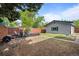 Backyard featuring a wooden fence, gray home, and outdoor seating area, great for relaxation and gatherings at 886 S Jersey St, Denver, CO 80224