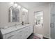 Modern bathroom featuring double sinks, marble countertops, and stylish arched mirrors at 886 S Jersey St, Denver, CO 80224