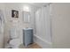 Bathroom featuring light blue vanity, white walls, mirror and tiled shower with tub at 886 S Jersey St, Denver, CO 80224