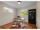Bedroom featuring wood floors, two windows, a desk and a black bookshelf at 886 S Jersey St, Denver, CO 80224