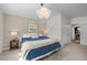 Cozy bedroom with a blue bedspread, soft lighting, bedside tables, and neutral walls for a relaxing ambiance at 886 S Jersey St, Denver, CO 80224
