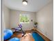 Bedroom featuring wood floors, a window, workout equipment and light yellow walls at 886 S Jersey St, Denver, CO 80224