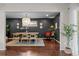 Stylish dining room with hardwood floors, black accent wall, modern lighting, and open layout at 886 S Jersey St, Denver, CO 80224