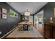 Elegant dining room features a large wooden table, stylish lighting, dark accent wall, and hardwood floors at 886 S Jersey St, Denver, CO 80224
