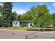 Suburban home boasting mature trees, tidy landscaping, and a well-maintained exterior at 886 S Jersey St, Denver, CO 80224
