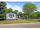A single-story home with a tidy lawn, mature trees, and great curb appeal at 886 S Jersey St, Denver, CO 80224