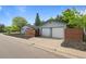 View of the garage and adjacent home with a wooden privacy fence, adding curb appeal at 886 S Jersey St, Denver, CO 80224