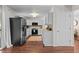 Spacious kitchen with white cabinets, black appliances, hardwood floors, and plenty of natural light at 886 S Jersey St, Denver, CO 80224