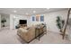 Living room with carpeted floors, recessed lighting and a large beige couch with side table at 886 S Jersey St, Denver, CO 80224