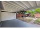 Covered patio overlooking backyard, featuring a privacy wall and seating area with fire pit at 886 S Jersey St, Denver, CO 80224
