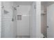 Contemporary shower featuring white subway tiles, glass door, and sleek fixtures, offering a spa-like experience at 886 S Jersey St, Denver, CO 80224