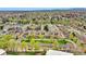 Wide aerial shot of a mature condo community complete with green spaces, parking, and mature trees at 7835 Barbara Ann Dr # C, Arvada, CO 80004