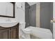 Nicely appointed bathroom featuring a combination shower and tub, toilet, and vanity with dark wood cabinets at 7835 Barbara Ann Dr # C, Arvada, CO 80004