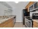 Galley kitchen featuring stainless steel appliances, stone countertops, and tiled floor at 7835 Barbara Ann Dr # C, Arvada, CO 80004
