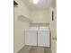 Functional laundry room with modern washer and dryer units and shelving at 7835 Barbara Ann Dr # C, Arvada, CO 80004