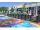 Local street view with colorful sidewalk art and outdoor dining areas at 7835 Barbara Ann Dr # C, Arvada, CO 80004