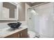 Updated bathroom with a modern bowl sink, marble countertops, and tiled glass enclosed shower at 8300 Fairmount Dr # J105, Denver, CO 80247