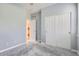 A light grey bedroom with closet doors at 8300 Fairmount Dr # J105, Denver, CO 80247